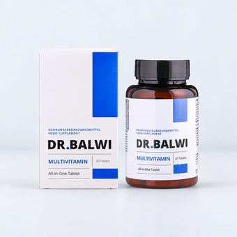 Eine Flasche Multivitamin Complex neben der weißen Kartonverpackung des Nahrungsergänzungsmittels.