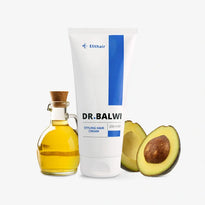 Eine Tube der Dr. Balwi Styling & Repair Creme von Dr. Balwi Shop steht neben einer kleinen Glasflasche Arganöl mit Korken und einer halbierten Avocado - ideal für geschmeidiges Haar auf weißem Hintergrund.